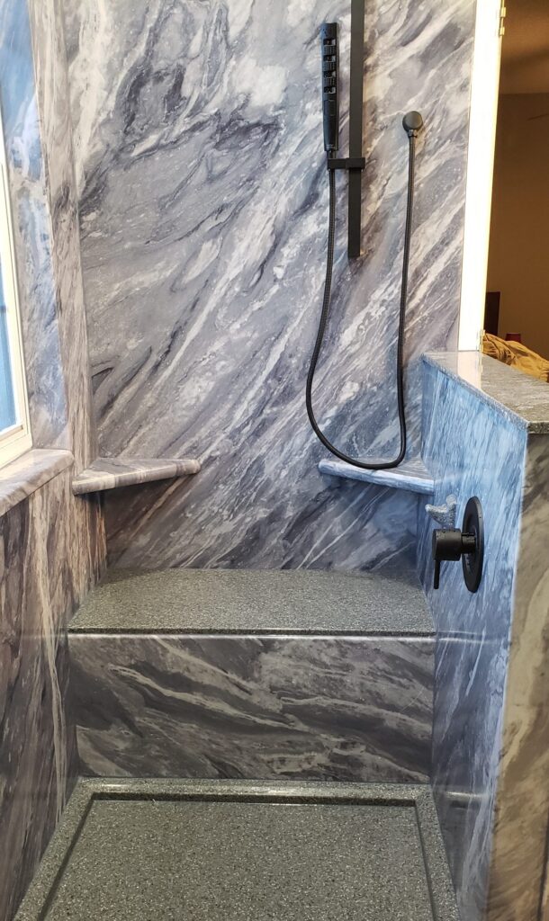 senior bathroom that has shower bench, shelves, and easy entry