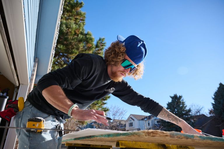 MyBath Colorado remodel expert measuring stone for a new shower on a sunny day
