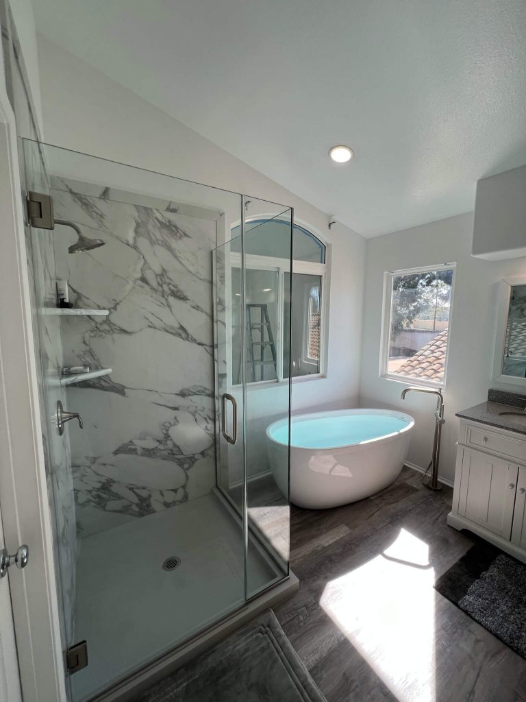 gorgeous freestanding bathtub and walk in shower with custom glass in an open and airy master bath