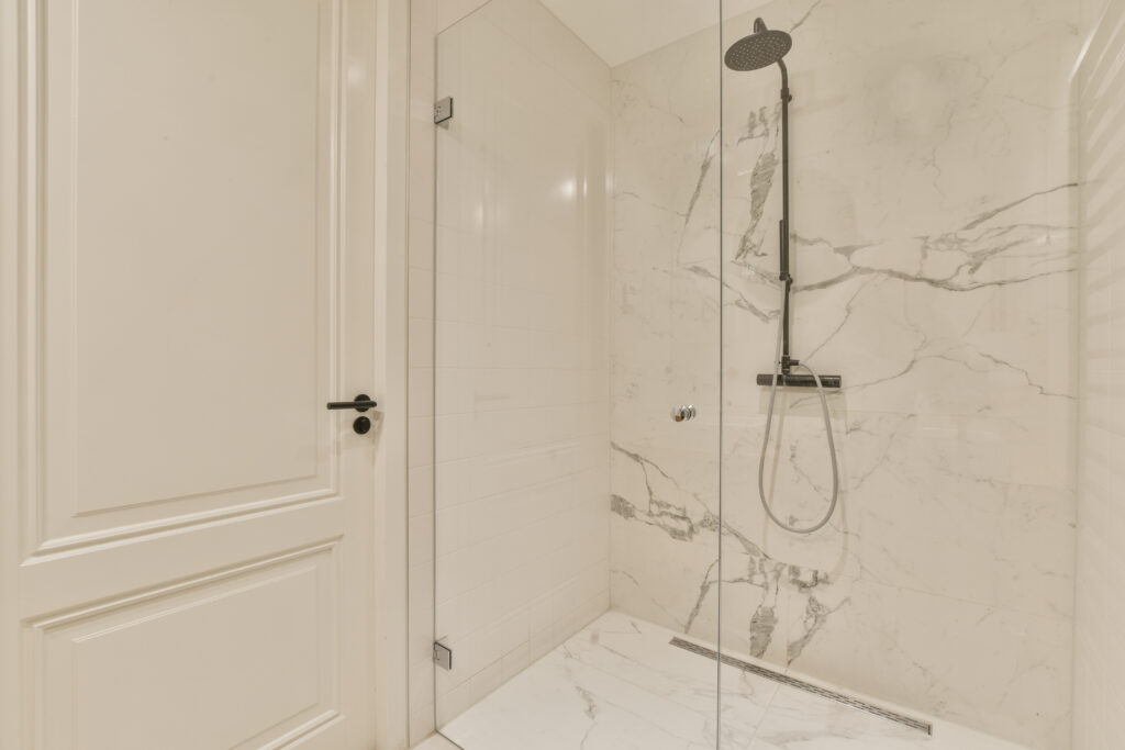 sleek shower renovation with bright, stone look surround in Denver Colorado